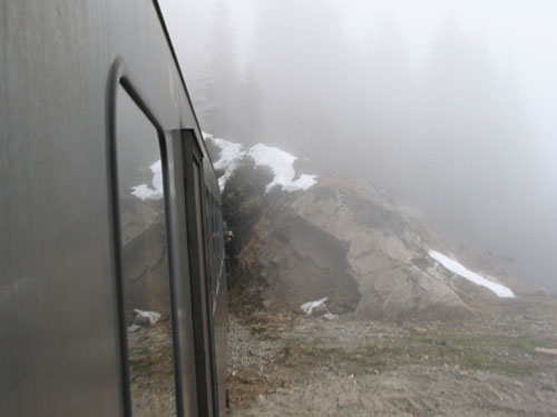 Train approaches a tunnel in the fog