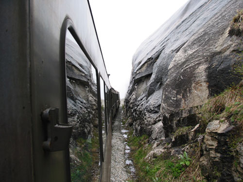 Train passes close to rocks