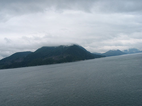 Mountains along the water on a cloudy day