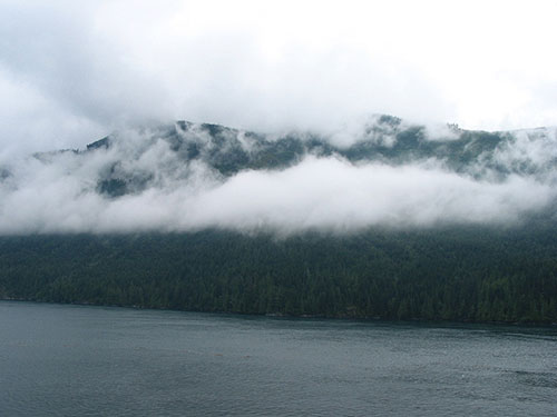 Clouds creeping over mountains and water