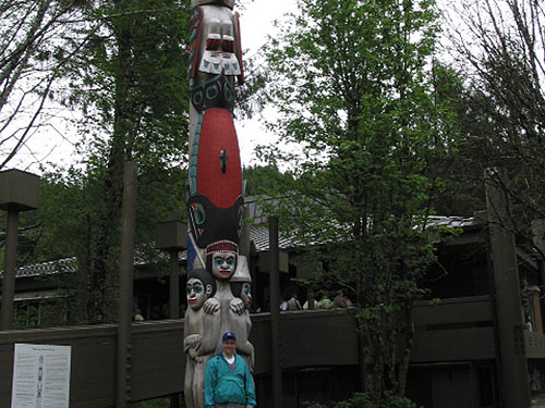 Pat stands in front of a totem pole