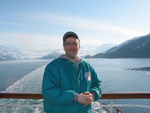 Pat smiling with College Fjord behind him