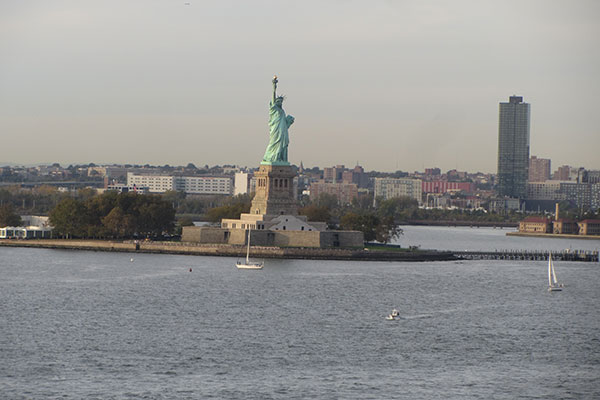 Cruise ship leaving Manhattan passing the Statue of Liberty