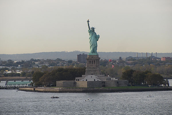 Ship cruises by Statue of Liberty