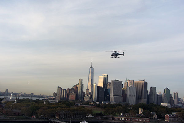Helicopter flies over city skyline