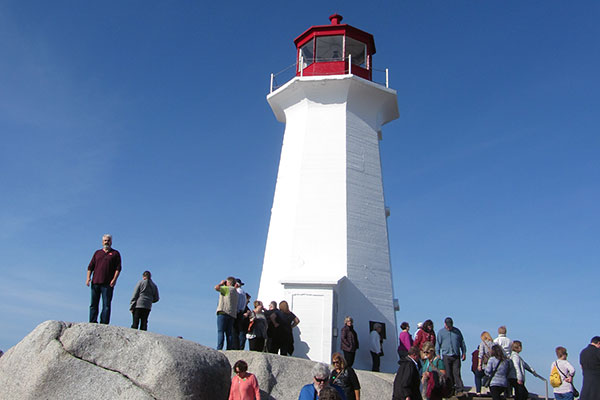 Tourists standing around lighthouse