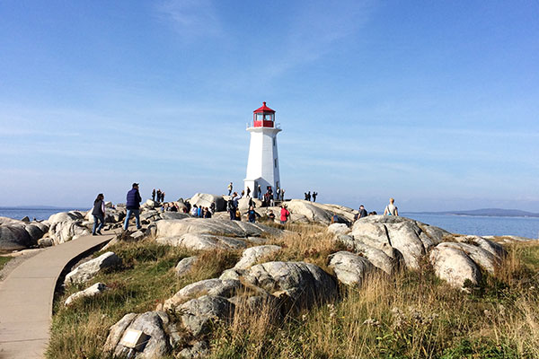 Lighthouse beyond rocks at Peggy's Cove