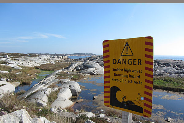 Danger sign by rocks