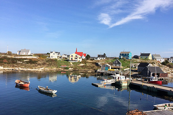 Very few clouds in sky above Peggy's Cove