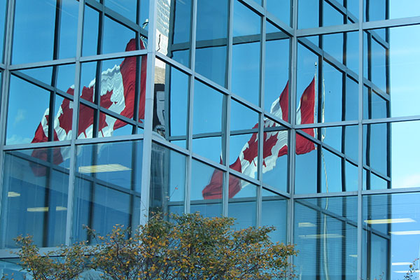 Canadian flag reflects in building