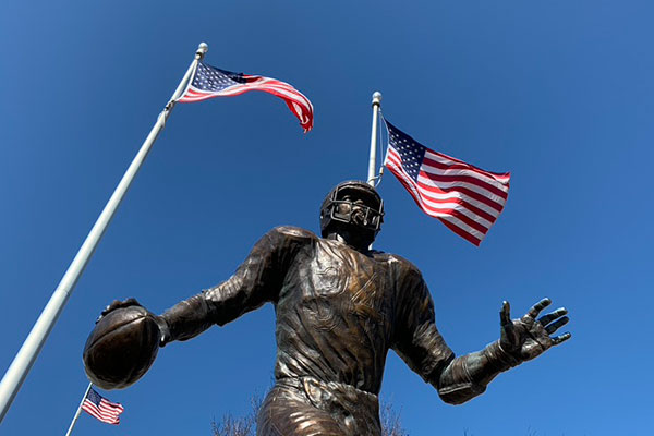 Walter Payton statue with flags in background