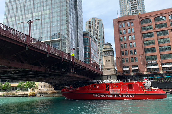 Fire boat passes under a bridge