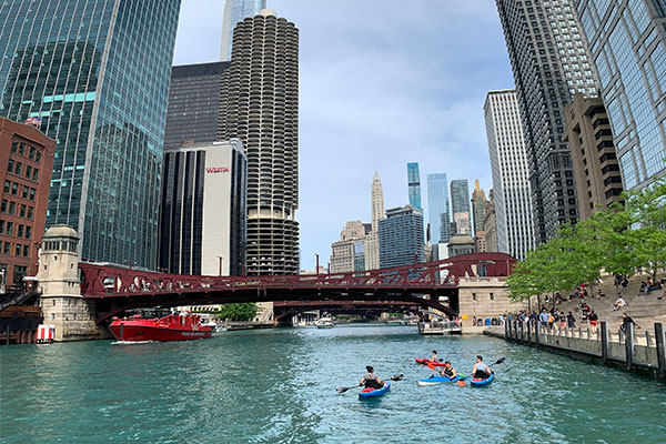 Boats pass under a bridge on the Chicago River near Marina Towers