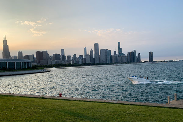 Chicago skyline behind Lake Michigan at dusk