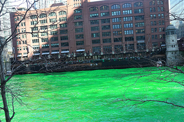 People watch the Chicago River being dyed green