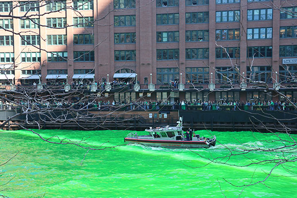Boat passes on the Chicago River after being dyed green