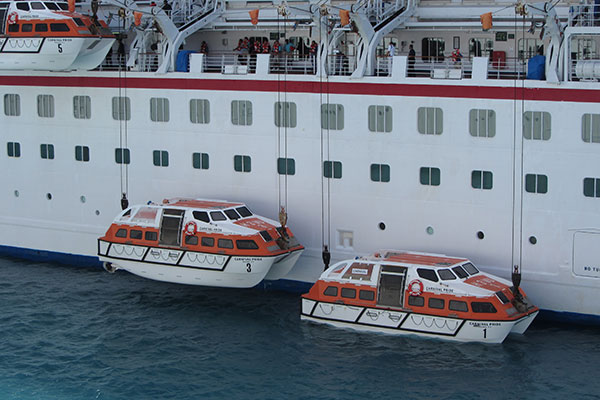 Two tender boats being lowered from ship