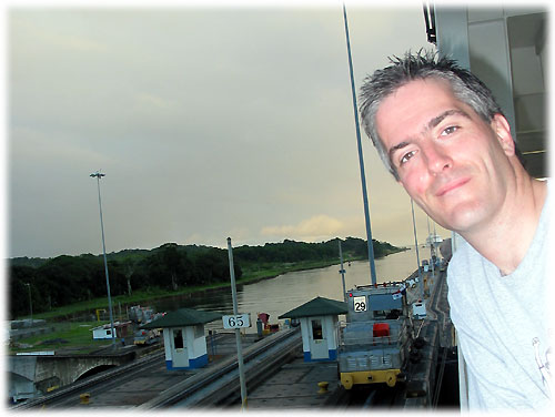 Pat standing on boat with locomotive behind him
