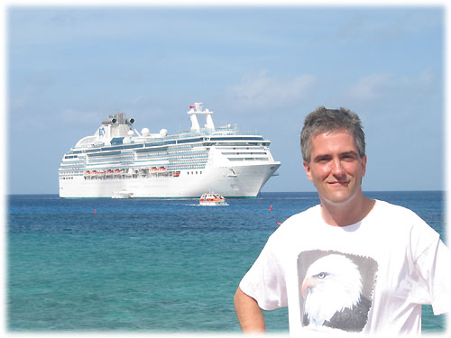 Pat standing on shore in front of the Coral Princess