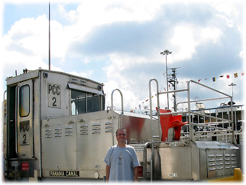 Pat stands in front of locomotive near Panama CIty