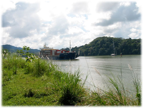 Train passes a ship on the canal