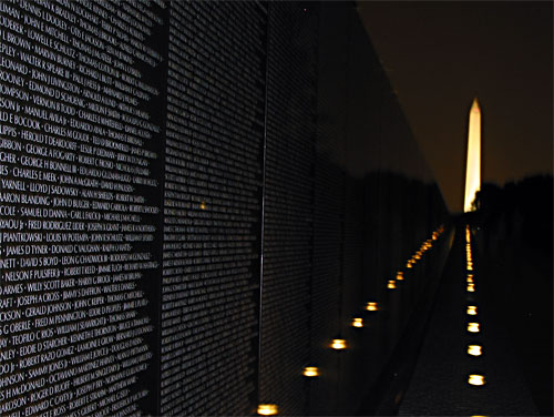Vietnam Veterans Memorial with Washington Memorial in background at night