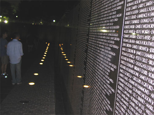 People at Vietnam Veterans Memorial at night
