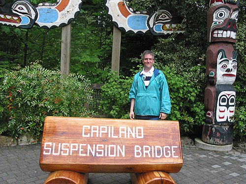 Pat in front of sign that reads Capilano Suspension Bridge