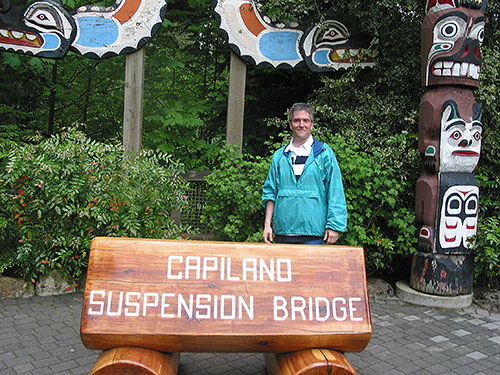 Pat in front of sign that reads Capilano Suspension Bridge