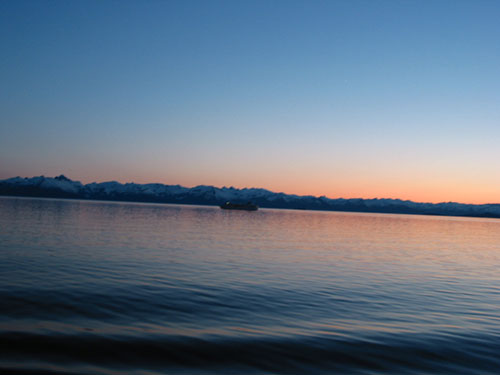 View of boat with sunset behind it