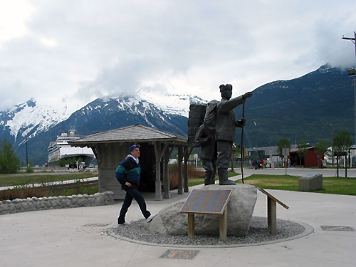 Pat standing near statue