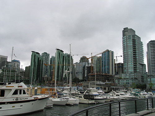 Boats at dock with skyline in background