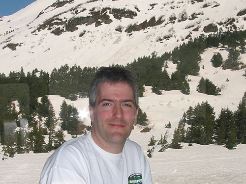 Pat in front of windows on train with snow in background