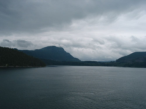 Clouds over the mountains beyond the water