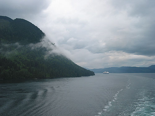 Cruise ship behind our ship cruises around a bend