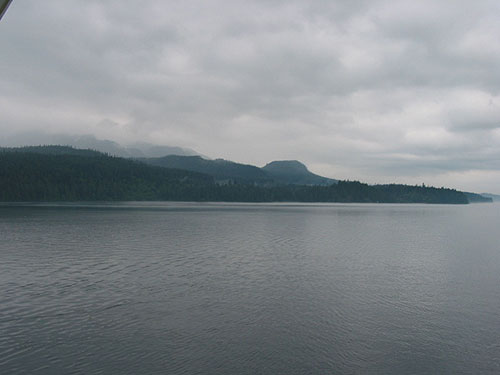 Water and low rising mountains beyond ship