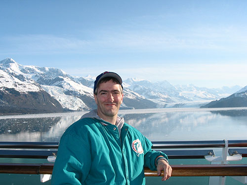 Pat along guard rail with College Fjord in background