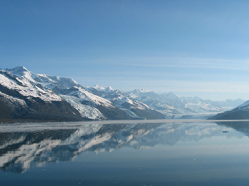 Mountains reflect over water