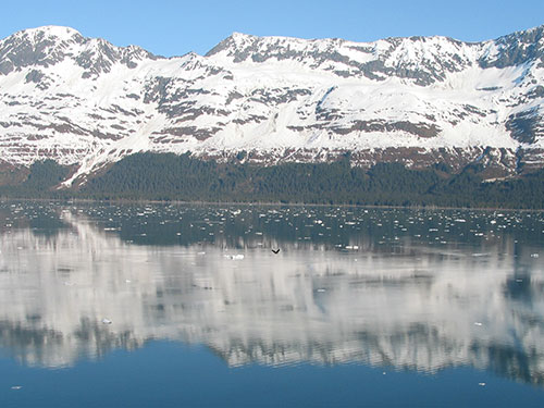 Mountain full of snow beyond the water