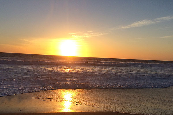 Sunset over water as seen from beach