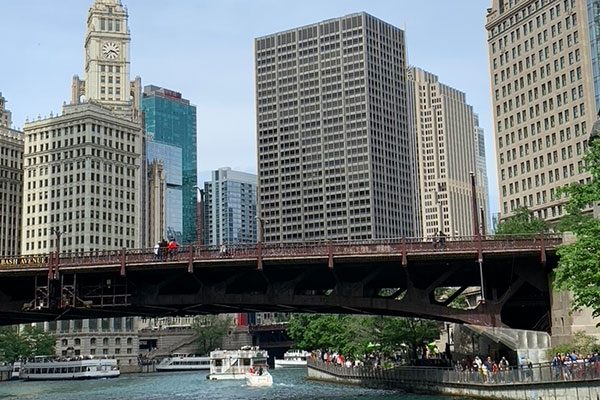 Boats pass under a bridge on the Riverwalk