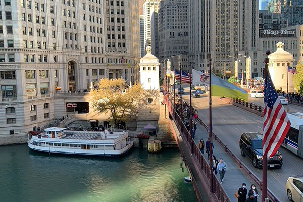 People cross Michigan Avenue Bridge