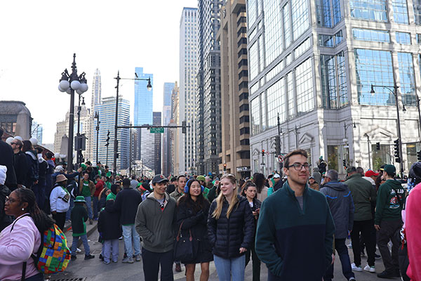 People leaving the dyeing of the Chicago River green