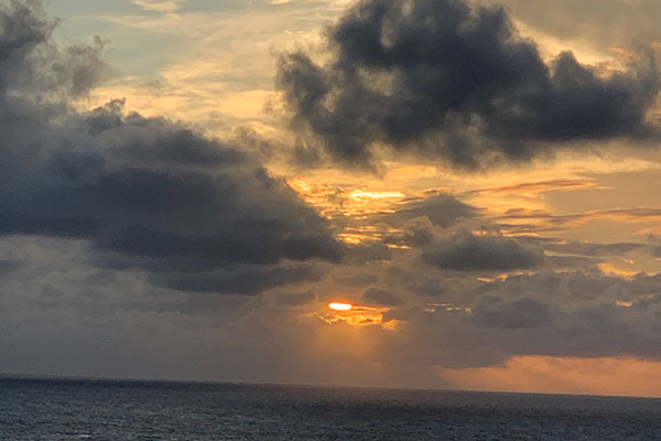 Sun coming out of clouds during sunset
