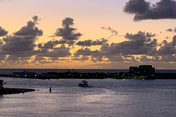 Sunrise in the harbor with boats and houses in background