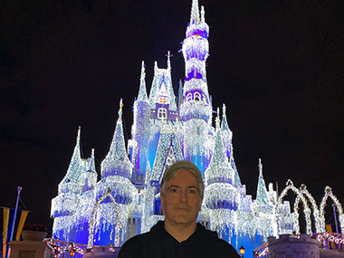 Pat in front of castle in Magic Kingdom
