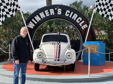 Pat standing by Herbie car