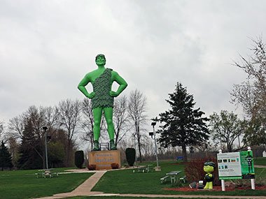 Pat at Jolly Green Giant Statue next to Little Sprout Statue