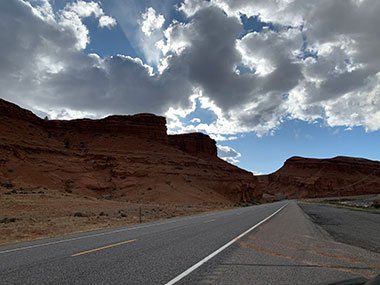 White line marks road by foothills