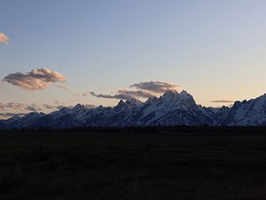 Field in shade of mountains